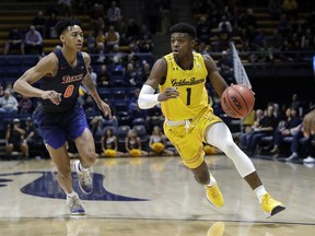 California guard Darius McNeill (1) dribbles past Cal State Fullerton guard Kyle Allman (0) during the first half of an NCAA college basketball game Saturday, Dec. 16, 2017, in Berkeley, Calif.