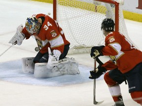 Panthers goalie James Reimer blocks the puck as teammate Mark Pysyk looks on during the third period against the Montreal Canadiens, on Saturday night in Sunrise, Fla.