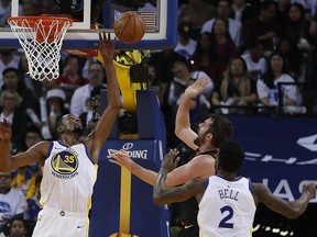 Golden State Warriors forward Kevin Durant (35) blocks a shot by Cleveland Cavaliers forward Kevin Love (0) during the second half of an NBA basketball game in Oakland, Calif., Monday, Dec. 25, 2017. The Warriors won 99-92.