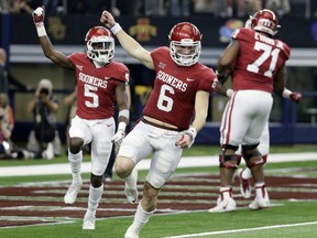 Oklahoma quarterback Baker Mayfield (6) and wide receiver Marquise Brown (5) celebrate hooking up for a long pass and touchdown score in the second half of the Big 12 Conference championship NCAA college football game against TCU on Saturday, Dec. 2, 2017, in Arlington, Texas.