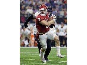 Oklahoma quarterback Baker Mayfield, front, is chased out of the pocket by TCU defensive tackle Ross Blacklock, rear, in the second half of the Big 12 Conference championship NCAA college football game, Saturday, Dec. 2, 2017, in Arlington, Texas.