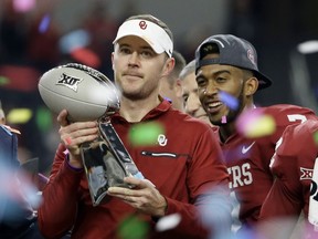 Oklahoma head coach Lincoln Riley holds the Big 12 Conference championship NCAA college football game trophy after Oklahoma defeated TCU on Saturday, Dec. 2, 2017, in Arlington, Texas.