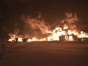 In this Dec. 18, 2017 photo provided by Shelby Wolden, Rainy Lake Oil Co., erupts in huge balls of fire fueled by eight or nine tanks inside the company's warehouse in International Falls, Minn. Office manager Janelle Heem says the warehouse, office and gas station were destroyed. She says the company has set up a temporary office in International Falls and is making fuel deliveries with four trucks that were spared in the fire.