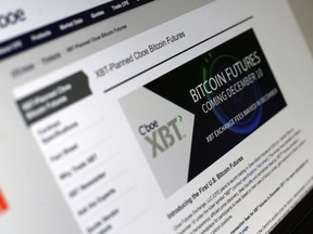 This Friday, Dec. 8, 2017, photo shows the Chicago Board Options Exchange website announcing that bitcoin futures will start trading on the CBOE on Sunday evening, Dec. 10. Bitcoin futures will start trading a week later on the Chicago Mercantile Exchange.