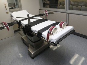 FILE - This Oct. 9, 2014, file photo shows the gurney in the the execution chamber at the Oklahoma State Penitentiary in McAlester, Okla. A state with one of the busiest death chambers in the country in recent decades, Oklahoma will enter its third year without an execution in 2018 while prison officials and state attorneys work to fine tune its procedure for putting condemned inmates to death.