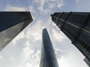 The Shanghai Tower, centre, stands next to the Shanghai World Financial Center, left, and the Jinmao Tower, right, in Shanghai, China, on Friday, Dec. 1, 2017. After more than two years of red tape that kept tenants from moving in, China's tallest skyscraper, the Shanghai Tower, has been quietly opening and filling office space.