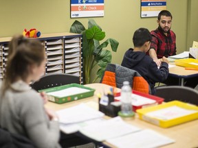 A tutor works with students at an Oxford Learning program in Toronto on Thursday, December 7, 2017.