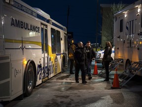 An multi-patient ambulance and and SIU mobile unit are photographed after a gunman was killed by police at a bank in Maple, Ont., on Wednesday, December 13, 2017.