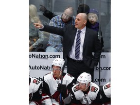 Arizona Coyotes head coach Rick Tocchet directs his team against the Colorado Avalanche in the first period of an NHL hockey game Wednesday, Dec. 27, 2017, in Denver.