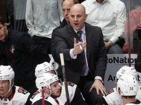 Arizona Coyotes coach Rick Tocchet talks to player during a timeout in the third period of the team's NHL hockey game against the Colorado Avalanche on Wednesday, Dec. 27, 2017, in Denver. The Coyotes won 3-1.