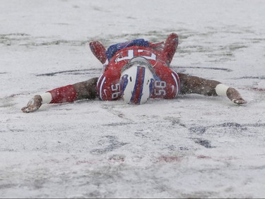 Buffalo Bills' Ryan Davis makes a snow angel on the field before an NFL football game between the Buffalo Bills and the Indianapolis Colts, Sunday, Dec. 10, 2017, in Orchard Park, N.Y. (AP Photo/Seth Wenig)