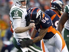 Denver Broncos outside linebacker Shane Ray (56) tackles New York Jets quarterback Josh McCown (15) during the second half of an NFL football game, Sunday, Dec. 10, 2017, in Denver. McCown left the game after the hit.