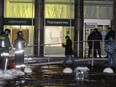 Police stand at the entrance of a supermarket, after an explosion in St.Petersburg, Russia, Wednesday, Dec. 27, 2017.