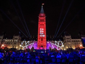 A Canada 150 projection is seen on Parliament Hill's Centre Block's at the conclusion of the illumination launch ceremony of Christmas Lights Across Canada, in Ottawa on Thursday, Dec. 7, 2017.