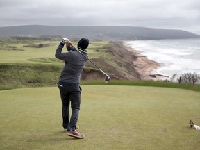 A golfer hits from the tee on the 528 yard, par 5, 18th hole at Cabot Cliffs in Inverness, N.S. on Wednesday, June 1, 2016.