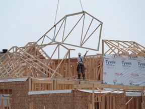 Construction workers build new homes in a development in Ottawa on Monday, July 6, 2015. The board of Canada's housing agency is getting a makeover as the Liberals look to cement the Canada Mortgage and Housing Corp. as a vehicle to deliver more affordable housing to millions of Canadians.