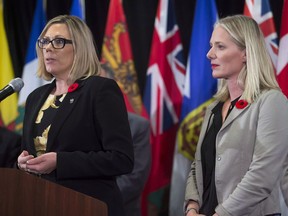Manitoba Environment Minister Rochelle Squires, left, responds to a question as Federal Environment Minister Catherine McKenna listens during a news conference after a Canadian Council of Ministers of the Environment meeting in Vancouver on Friday, November 3, 2017.