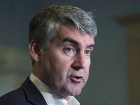Nova Scotia Premier Stephen McNeil talks with reporters at the legislature in Halifax on Wednesday, May 31, 2017. McNeil says he fully intends to seek a third mandate as premier of the province.