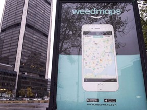 A sign advertising a Weedmaps mobile phone app Thursday, November 2, 2017 in Montreal. Several Montreal billboards promoting an app that lists local pot providers appear to have been taken down after at least one citizen complained. THE CANADIAN PRESS/Paul Chiasson