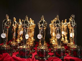 This March 2, 2014 file photo shows Oscar statues lined up backstage during the Oscars in Los Angeles. Canadian members of the Academy of Motion Picture Arts and Sciences say they're hopeful the organization's newly released code of conduct will have an impact.The academy, which oversees the Oscars, says members must behave "ethically" with "respect for human dignity, inclusion, and a supportive environment that fosters creativity."