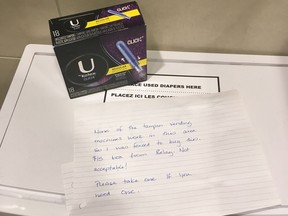 An anonymous note and a $15 box of tampons is shown in a women's washroom at the Calgary International Airport on Nov. 26, 2017. Though many shocked at the price, women in remote Indigenous communities often pay that much or more for feminine hygiene products, according to the organization Moon Time Sisters. THE CANADIAN PRESS/HO-Carlee Field MANDATORY CREDIT