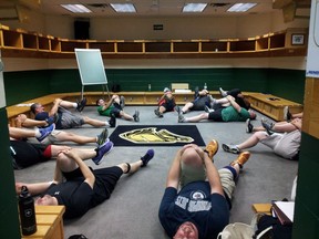 Men participating in the University of Western Ontario's Hockey Fans In Training program, funded by the Movember Foundation, stretch in the London Knights locker room in this undated handout photo. A team of Canadian researchers is recruiting overweight male hockey fans for a new study that aims to turn a passion for sports into healthier lifestyles. The hockey fans in training program, piloted at Western University in London, Ont., is being rolled out by researchers at the University of New Brunswick in Fredericton in January.