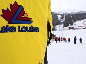 A Lake Louise guest host directs skiers off the mountain after a power failure shut down all operations prior to the women's World Cup downhill race in Lake Louise, Alta., on Saturday, Dec. 2, 2017. A 17-year-old ski racer from a club in Germany has died in a Calgary hospital after he was seriously injured during a NorAm event at Lake Louise, Alta.RCMP says the racer lost control during his run on Tuesday afternoon and died from his injuries Wednesday in a Calgary hospital.