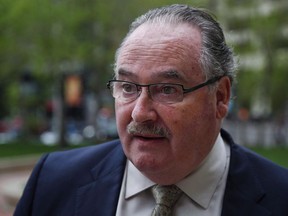 Alberta Minister of Infrastructure and Minister of Transportation Brian Mason arrives for a cabinet meeting in Calgary, Alta., on May 28, 2015. Alberta is officially challenging Saskatchewan's licence plate ban, filing the paperwork to have the issued resolved by an arbitration panel under the free trade New West Partnership.