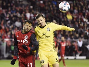 Toronto FC defender Steven Beitashour (33) and Columbus Crew forward Pedro Santos (32) battle for the ball during first half MLS eastern conference semifinal playoff soccer action in Toronto on Wednesday, November 29, 2017. Beitashour has had to do things the hard way ever since he took up soccer. This year was no different as Beitashour had to survive a dangerous on-field collision, undergo pancreas surgery and then fight off competition for his job.