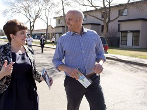 Alberta Party candidate Cristina Stasia, left, and Alberta Party Leader Greg Clark go door knocking while on the campaign trail in Edmonton on April 27, 2015. The interim leader of the Alberta party says he has decided to not run a second time for the top job. Greg Clark says while he still will run again in 2019 to retain his seat in Calgary-Elbow, he wants to spend more time with his family, which wouldn't be possible if he was leader.