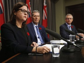 Manitoba Premier Brian Pallister (C) and Growth, Enterprise and Trade Minister Blaine Pedersen (R) listen in as Justice Minister Heather Stefanson talks about the Manitoba plan for cannabis retail and distribution at the Manitoba Legislature in Winnipeg, Tuesday, November 7, 2017.