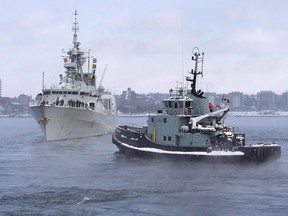 The naval tugboat Glenivis assists as HMCS St. John's heads to the Mediterranean in Halifax on Monday, Jan. 9, 2017. The federal government is trying to keep its multi-billion-dollar plan to build new warships for the navy from capsizing by shooting down a French and Italian consortium's controversial proposal.THE CANADIAN PRESS/Andrew Vaughan