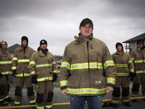 Firefighter Mark Stephenson (C) with fellow firefighters raising money at a charity event, filmed his house burning in the Abasand neighbourhood last year during the wildfires in Fort McMurray, Alta. Friday, April 22, 2017.