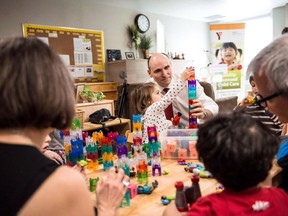 A new report shows child care costs are rising faster than inflation, straining pocketbooks and raising questions about whether billions in new federal spending will make daycare more affordable for those who want it. Jean-Yves Duclos, minister of Families, Children and Social Development, plays with children at a YMCA daycare in downtown Toronto before an announcement, in Toronto on Wednesday, March 29, 2017.