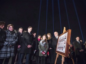 Beams of light, one for each victim, shine over Prime Minister Justin Trudeau as he takes part in a memorial ceremony for the fourteen women murdered at Ecole Polytechnique in Montreal asshown in this file photo Sunday, Dec. 6, 2015. Canadians will commemorate the 28th anniversary today of the Montreal Massacre when a gunman shot 14 women to death and injured 14 other people.