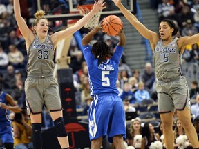 Connecticut's Katie Lou Samuelson (33) and Gabby Williams (15) guard against Memphis' Brea Elmore (5) in the first half of an NCAA college basketball game Sunday, Dec. 31, 2017, in Hartford, Conn.