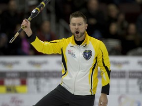 Mike McEwen of Winnipeg celebrates after improving to 3-0 at the Olympic Curling Trials Monday in Ottawa. Kevin Koe of Calgary is the only other unbeaten men's rink in the competition at 4-0.