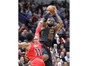Cleveland Cavaliers' LeBron James, right, shoots over Chicago Bulls' David Nwaba during the first half of an NBA basketball game Monday, Dec. 4, 2017, in Chicago.