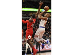 New York Knicks' Jarrett Jack, right, goes up to shoot against Chicago Bulls' Kris Dunn (32) during the first half of an NBA basketball game Wednesday, Dec. 27, 2017, in Chicago.