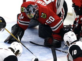 Chicago Blackhawks goalie Corey Crawford (50)  stops a shot from the Arizona Coyotes during the third period of an NHL hockey game Sunday, Dec. 10, 2017, in Chicago.