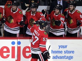 Chicago Blackhawks right wing Tommy Wingels (57) celebrates with teammates after scoring a goal against the Minnesota Wild during the third period of an NHL hockey game, Sunday, Dec. 17, 2017, in Chicago. The Blackhawks won 4-1.