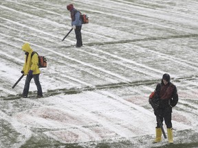 Workers clear snow from Soldier Field before an NFL football game between the Chicago Bears and Cleveland Browns in Chicago, Sunday, Dec. 24, 2017.