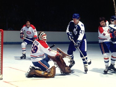 Darryl Sittler and Ken Dryden search for the puck in the 1970s.