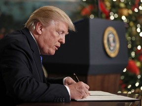 President Donald Trump signs a proclamation in the Diplomatic Reception Room of the White House, Wednesday, Dec. 6, 2017, in Washington. Trump recognized Jerusalem as Israel's capital despite intense Arab, Muslim and European opposition to a move that would upend decades of U.S. policy and risk potentially violent protests.