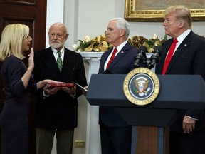President Donald Trump, right, watches as Kirstjen Nielsen is sworn in as the new Secretary of Homeland Security by Vice President Mike Pence, in the Roosevelt Room of the White House, Friday, Dec. 8, 2017, in Washington.