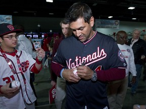 Washington Nationals Manager Dave Martinez sign autographs to children during the Winter Fest celebration with fans at Washington Convention Center in Washington, Saturday, Dec. 16, 2017.