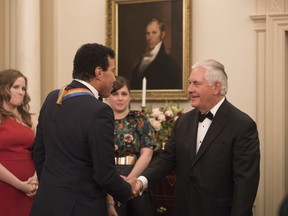 Secretary of State Rex Tillerson, right, meets with 2017 Kennedy Center Honoree Lionel Richie following the State Department dinner for the Kennedy Center Honors, Saturday, Dec. 2, 2017, in Washington.