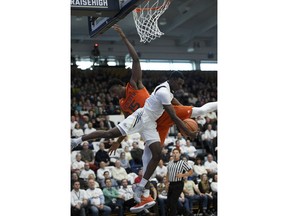 Miami center Ebuka Izundu (15) battles for the ball against George Washington guard Terry Nolan Jr. (1) during the first half of an NCAA college basketball game, Saturday, Dec. 16, 2017, in Washington.