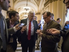 Reporters interview Sen. Mike Enzi, R-Wyo., chairman of the Senate Budget Committee, as arrives to meet with House Ways and Means Committee Chairman Kevin Brady, R-Texas, at the Capitol to advance the GOP tax bill, in Washington, Friday, Dec. 15, 2017.