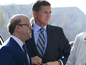Former Trump national security adviser Michael Flynn arrives at federal court in Washington, Friday, Dec. 1, 2017. Court documents show Flynn, an early and vocal supporter on the campaign trail of President Donald Trump whose business dealings and foreign interactions made him a central focus of Mueller's investigation, will admit to lying about his conversations with Russia's ambassador to the United States during the transition period before Trump's inauguration.  (AP Photo/Susan Walsh)